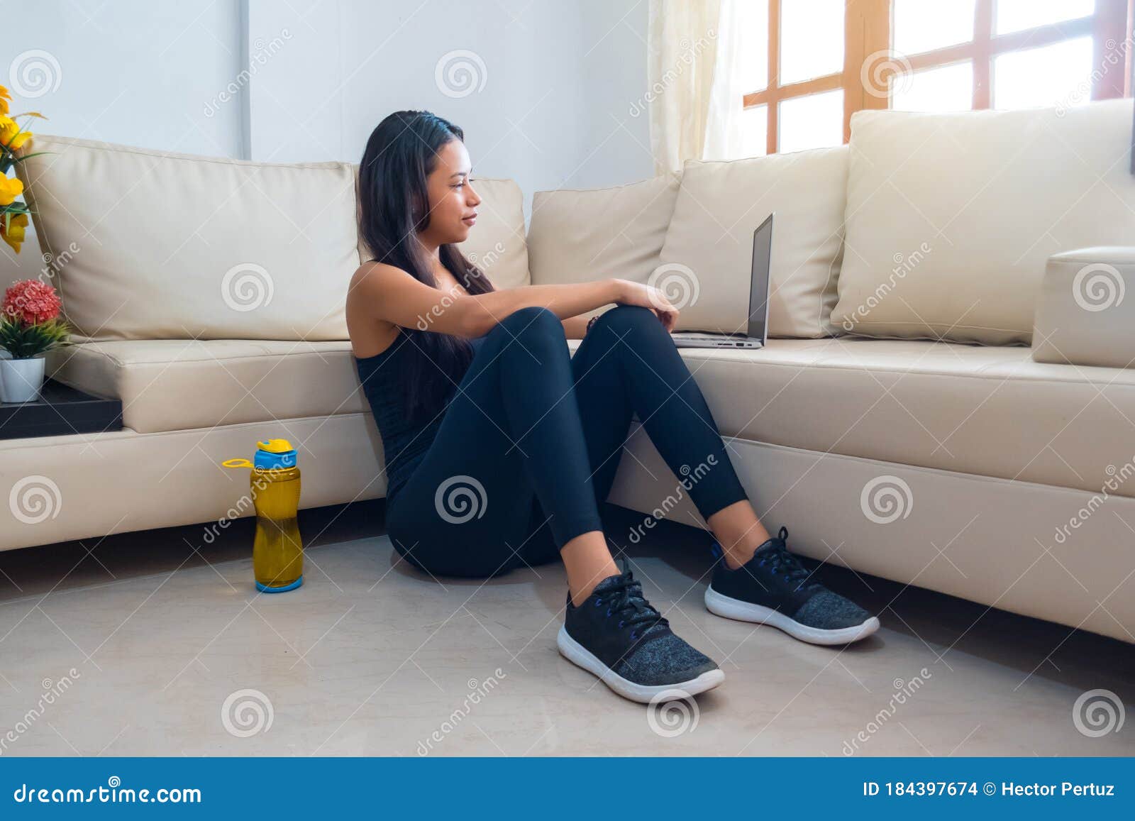 portrait of an attractive latina woman watching instructional videos on her laptop