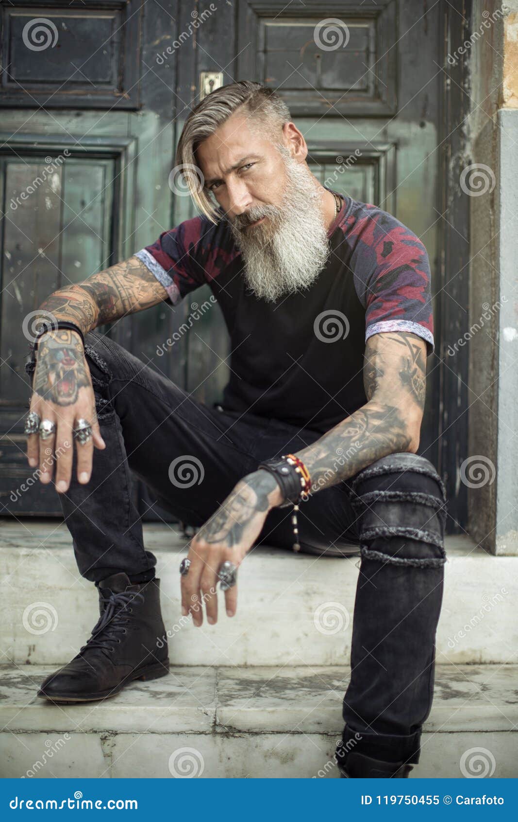 Portrait of an Attractive Man with a Beard and Tattoos in Front of a Green  Door Stock Image - Image of jeans, healthy: 119750455