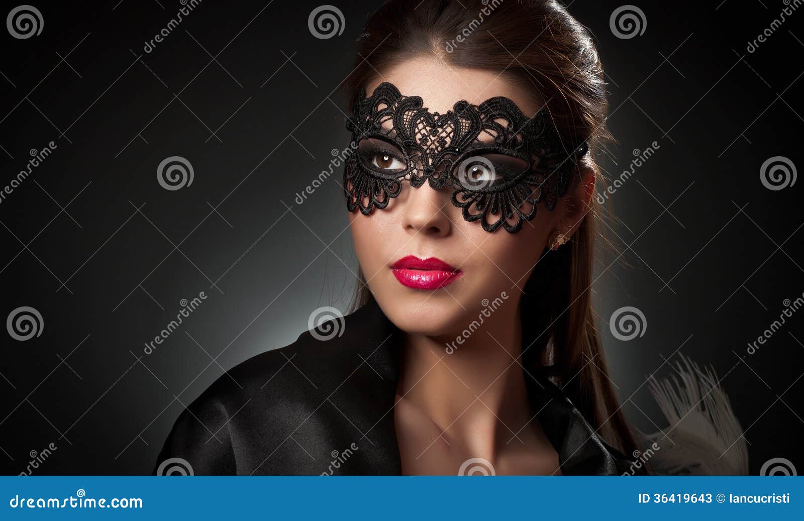portrait of attractive sensual young woman with mask. young attractive brunette lady posing on dark background in studio. portrait