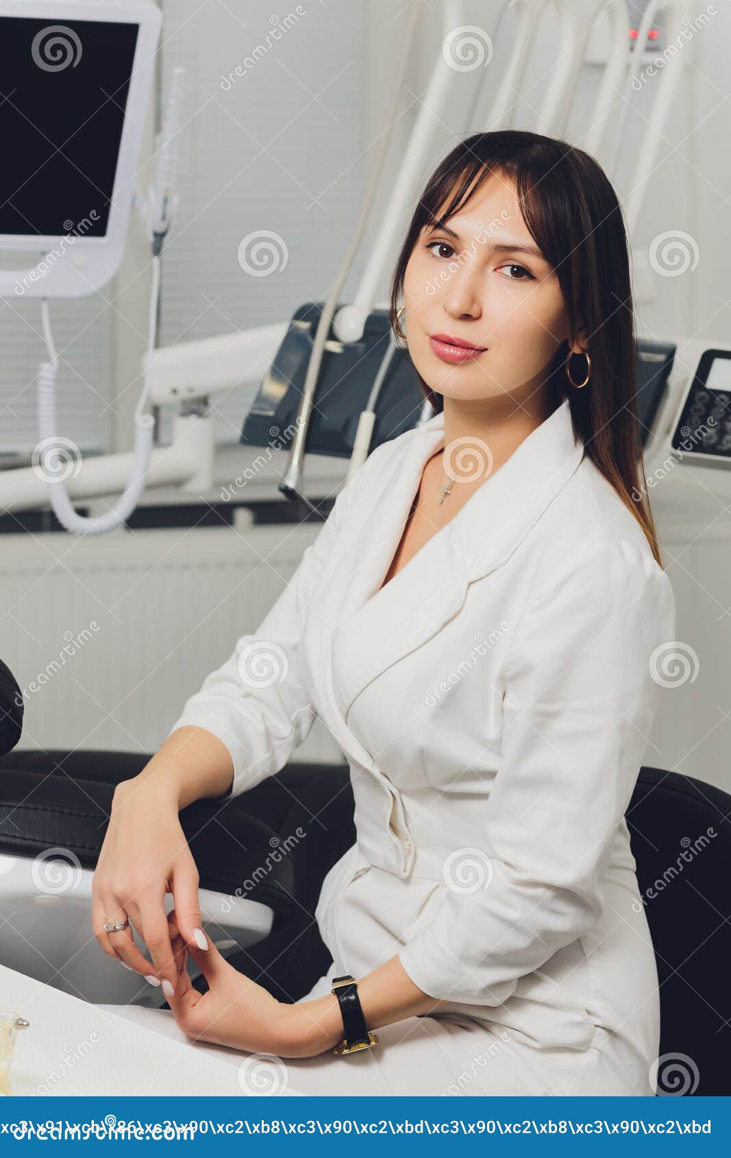 Portrait of Attractive Smiling Female Dentist with Hands Folded. Stock