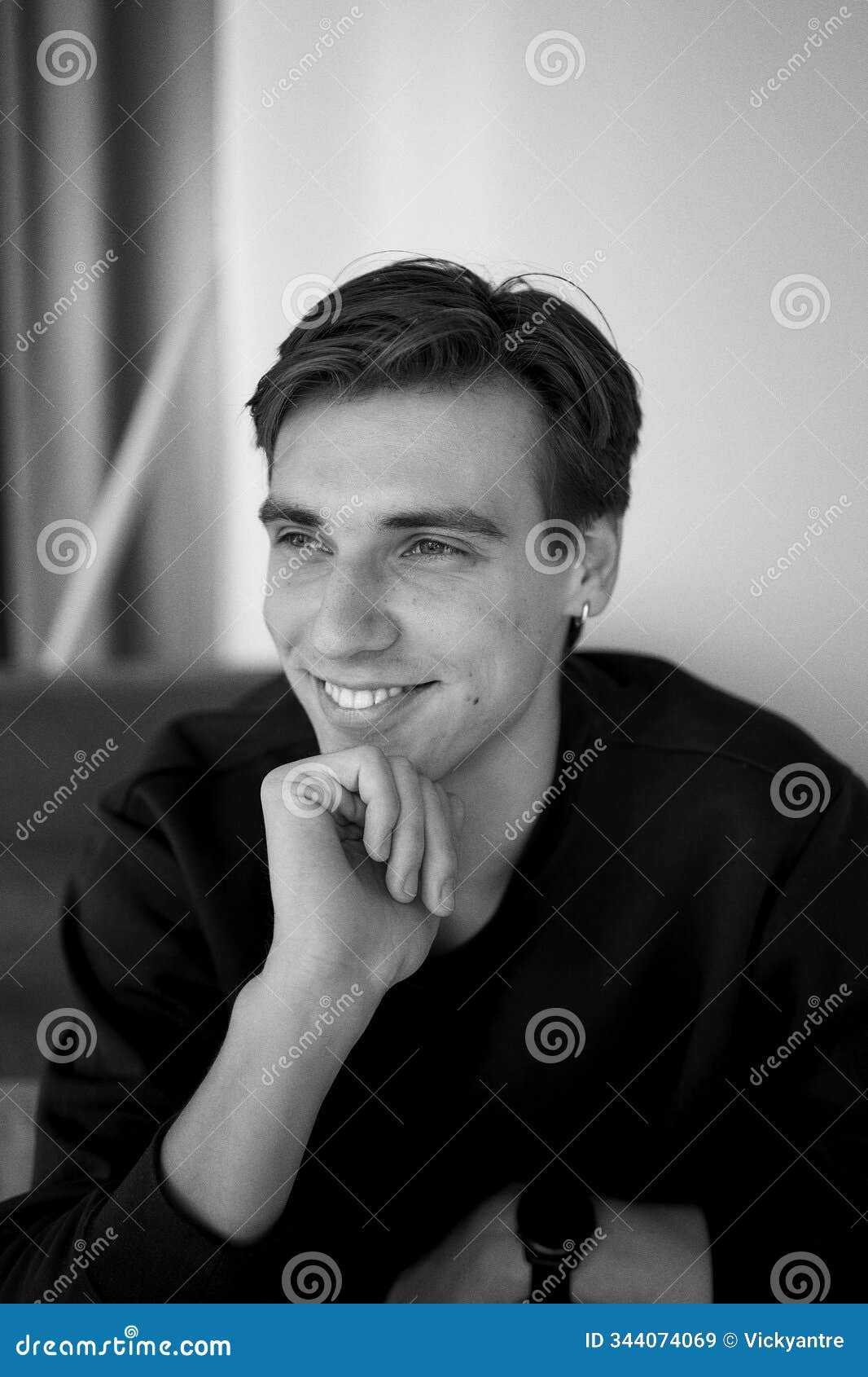 portrait of an attractive young 20 year old man with dark hair and blue eyes, studio photo shoot