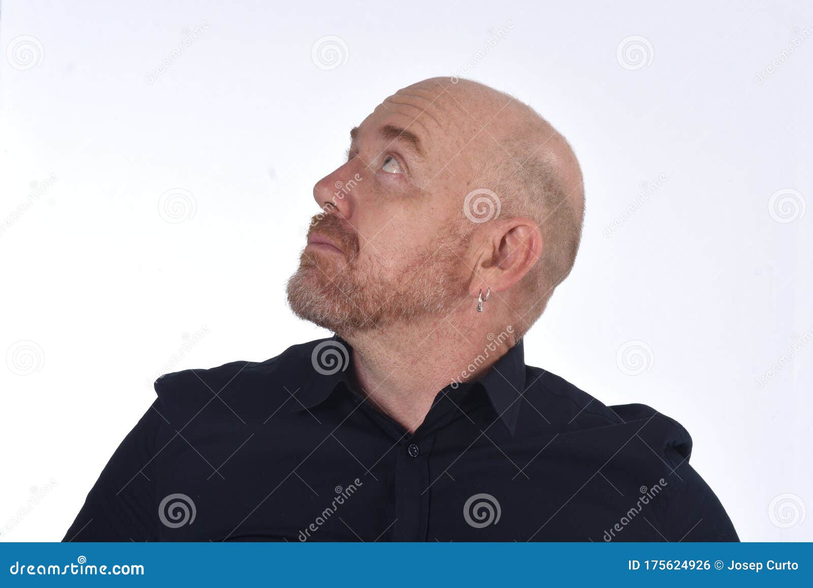 portrait of a bald man looking up on white