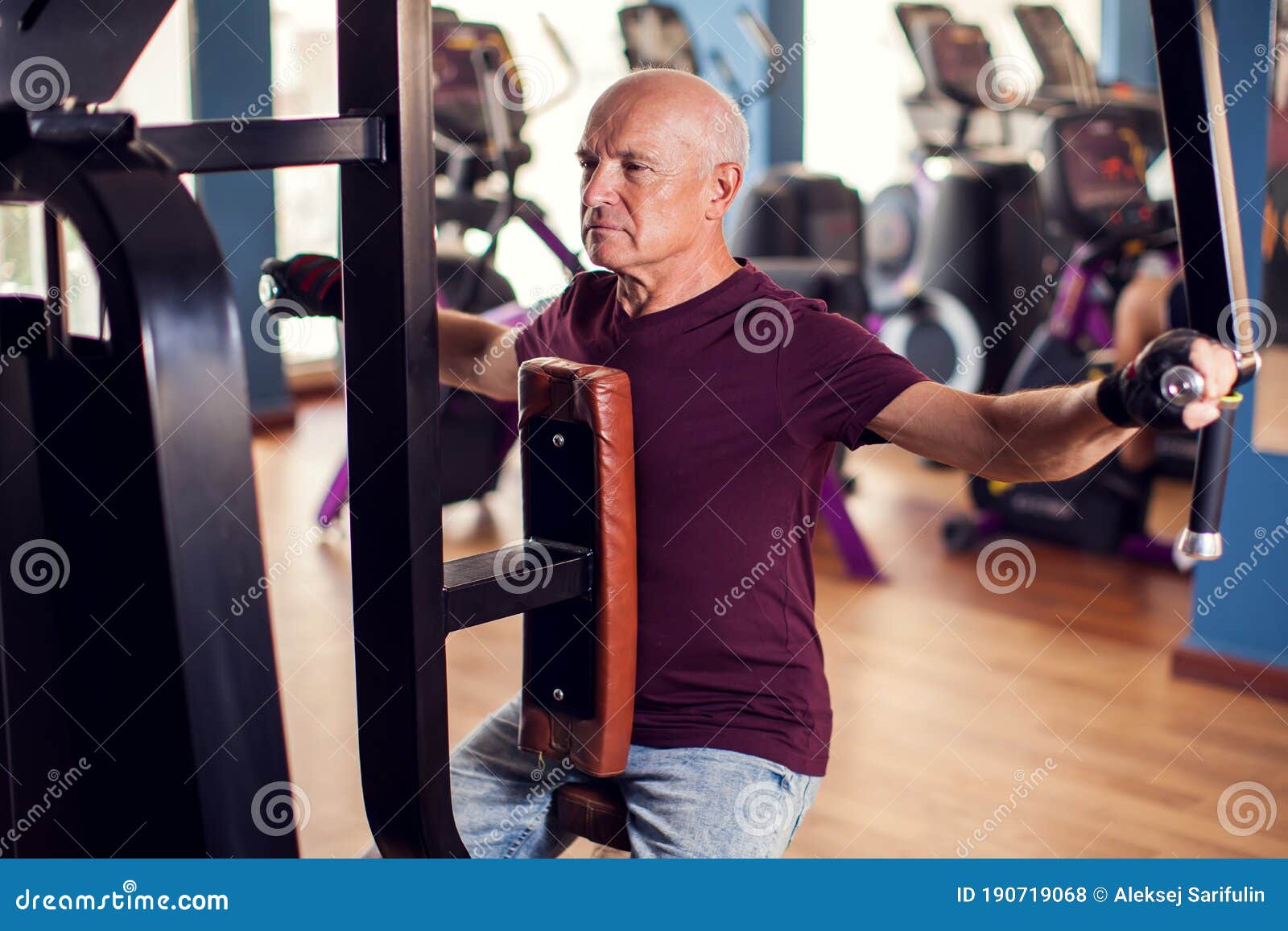 A Portrait of Senior Man in the Gym Training Back Muscles. People ...