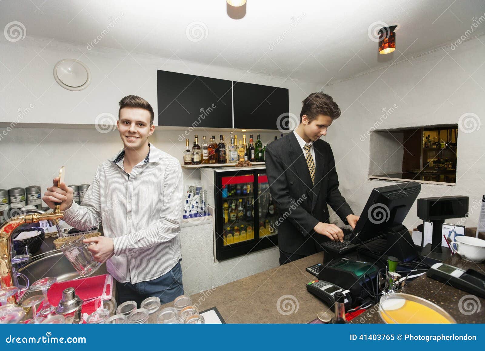 Portrait of Bartender with Cashier at Counter in Restaurant Stock Image