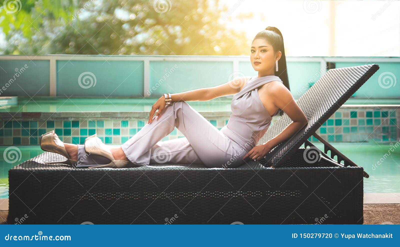 Beautiful Asian Woman Sitting And Enjoy Fresh Air Beside Swimming Pool