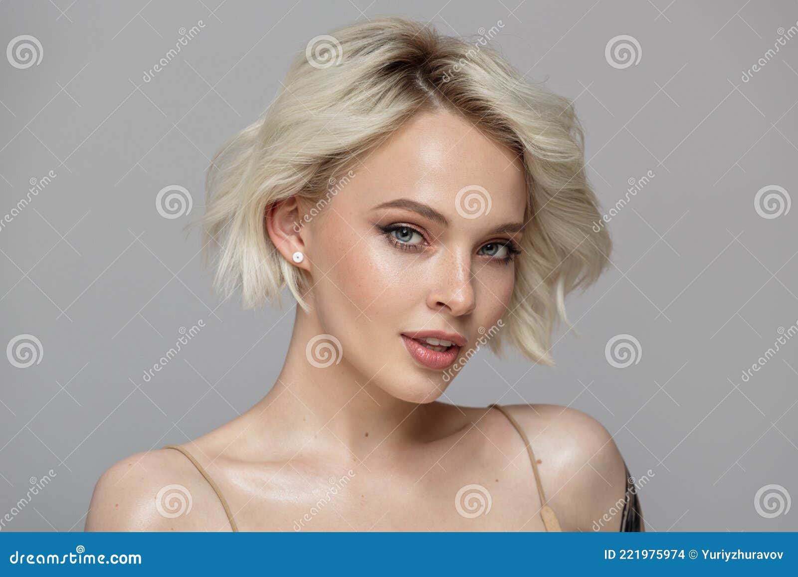 portrait of a beautiful blonde girl with a short haircut.