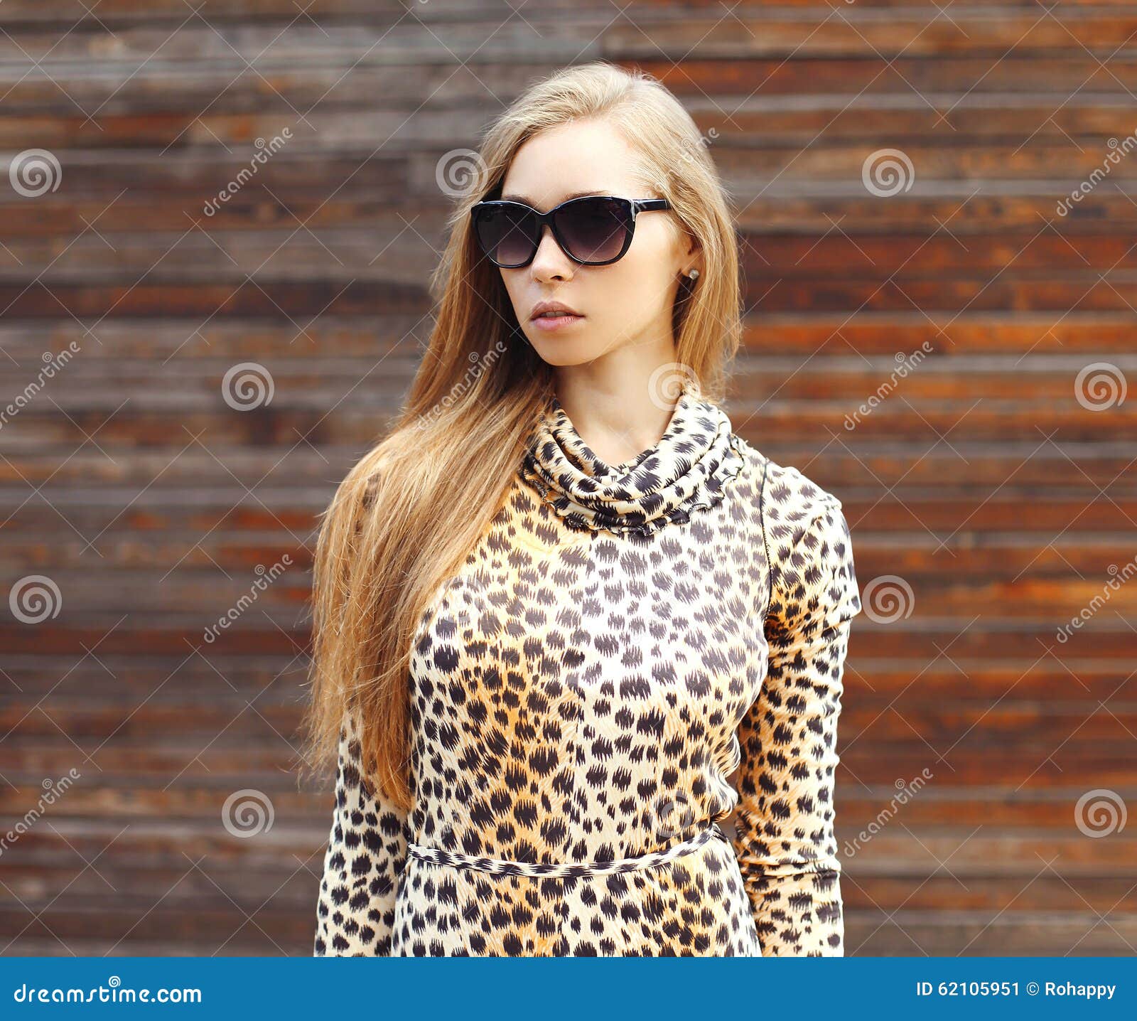 Portrait Of Beautiful Blonde Woman Wearing A Leopard Dress And