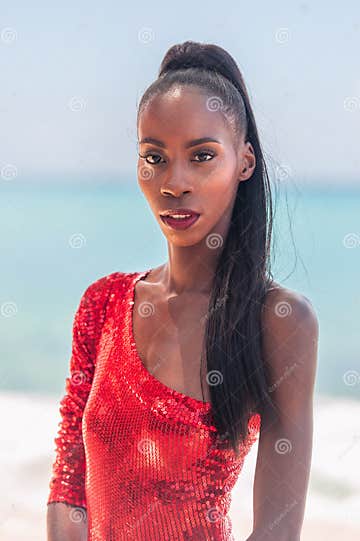 Portrait Of Beautiful Caribbean Adult Teen In Barbados Wearing Red