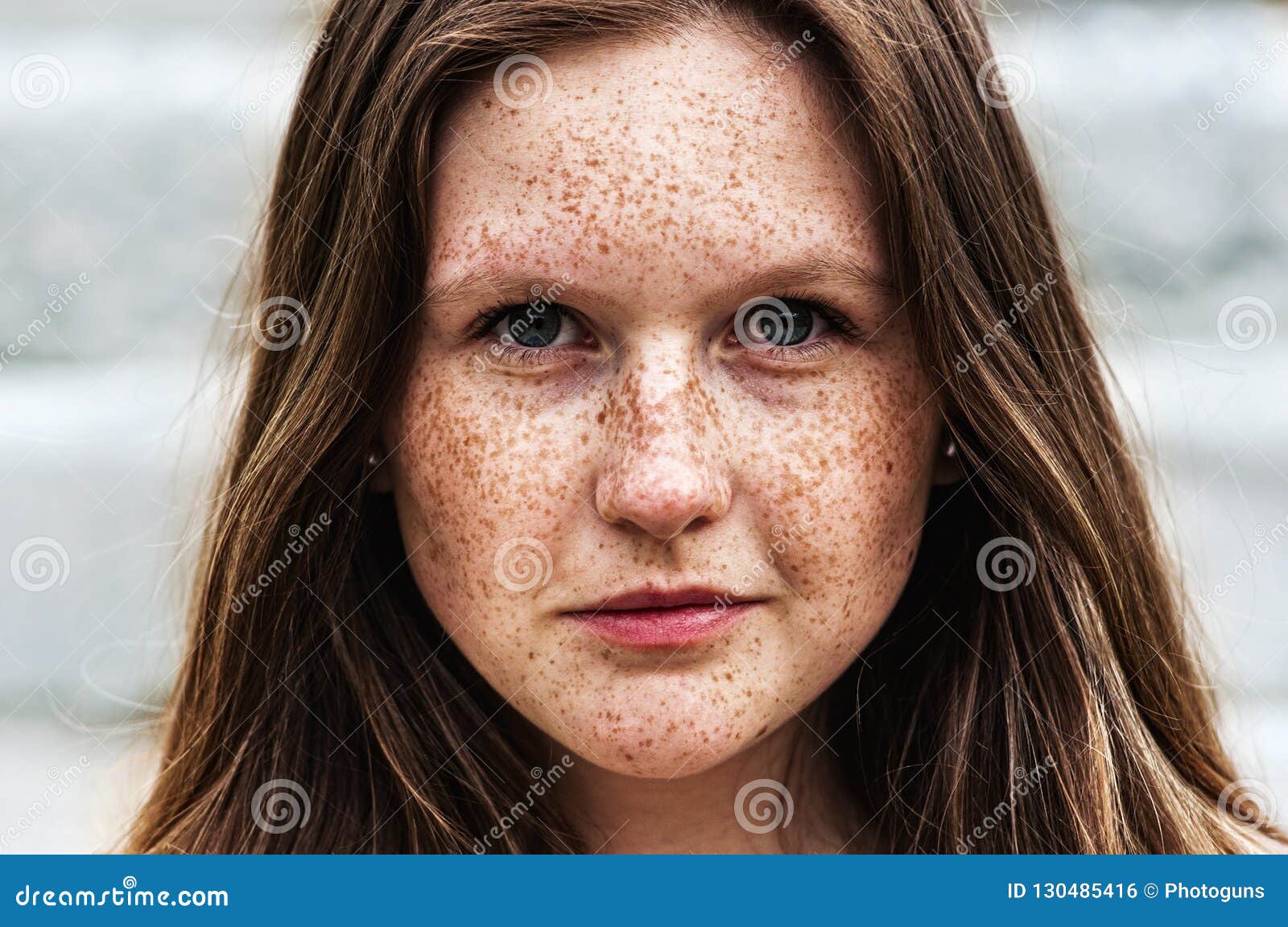 portrait of a beautiful redhead girl with freckles