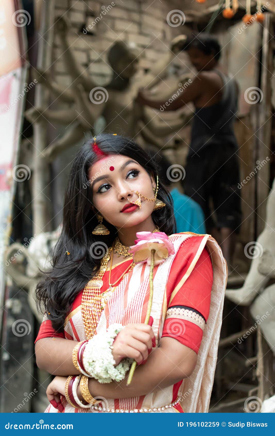 Portrait of Beautiful Indian Girl Standing in Front of Durga Idol Wearing  Traditional Indian Saree, Gold Jewellery, and Bangles. Stock Image - Image  of kumortuli, girl: 196102259