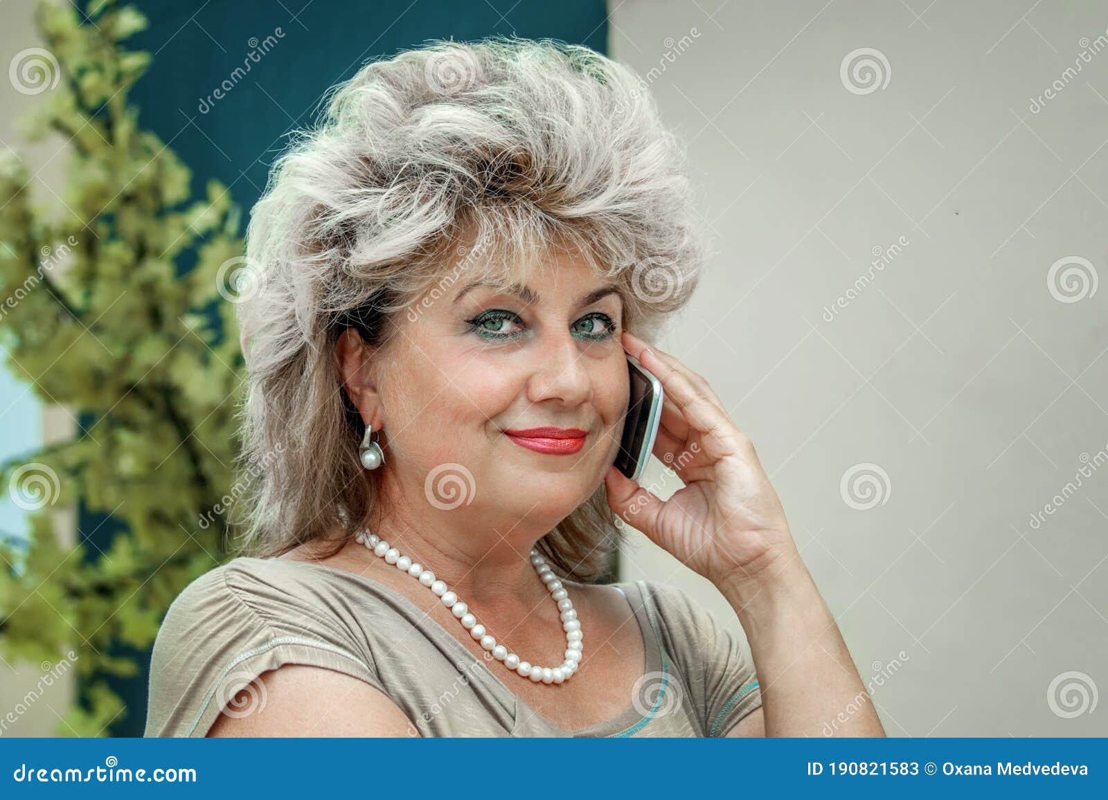 Portrait Of A Beautiful Mature Blonde Talking On The Phone The Woman 
