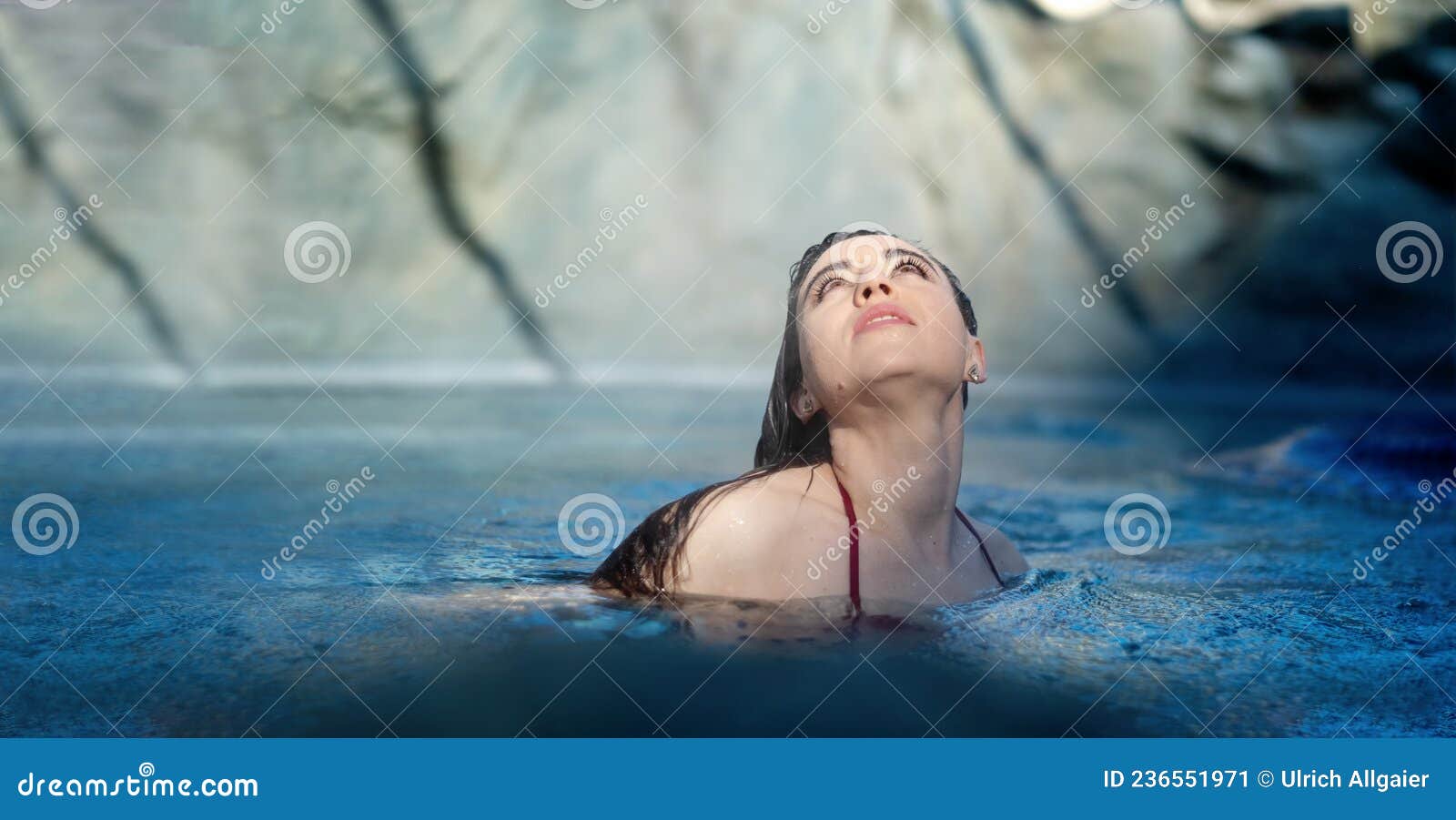 portrait of beautiful mature woman with dark hair relaxes contend happy in holidays summer sun in the blue spa wellness whirlpool