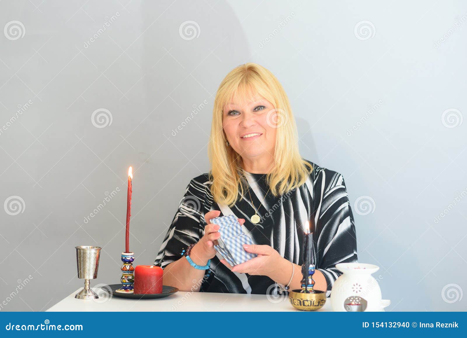 Portrait Of Beautiful Middle Age Woman Sits Near A Fortune Teller Desk With A Tarot Cards And ...