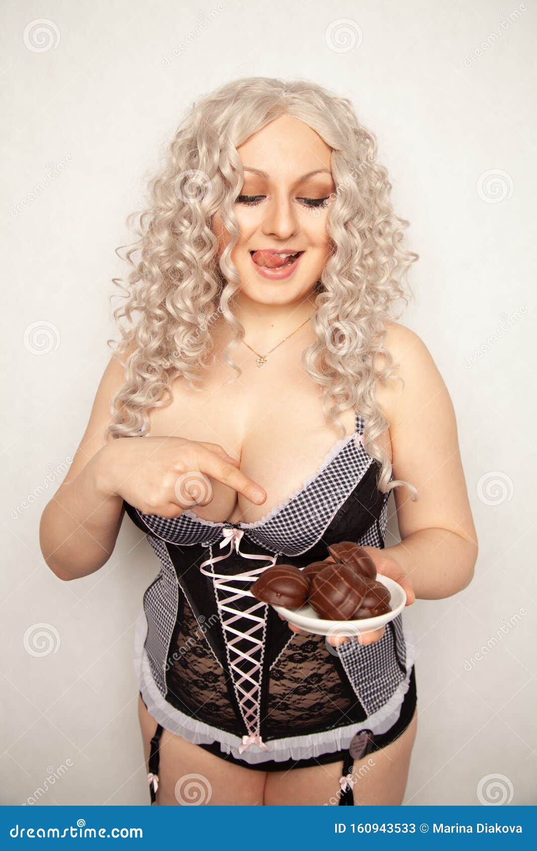 Portrait Of Beautiful Plus Size Curly Young Blond Woman Posing On White