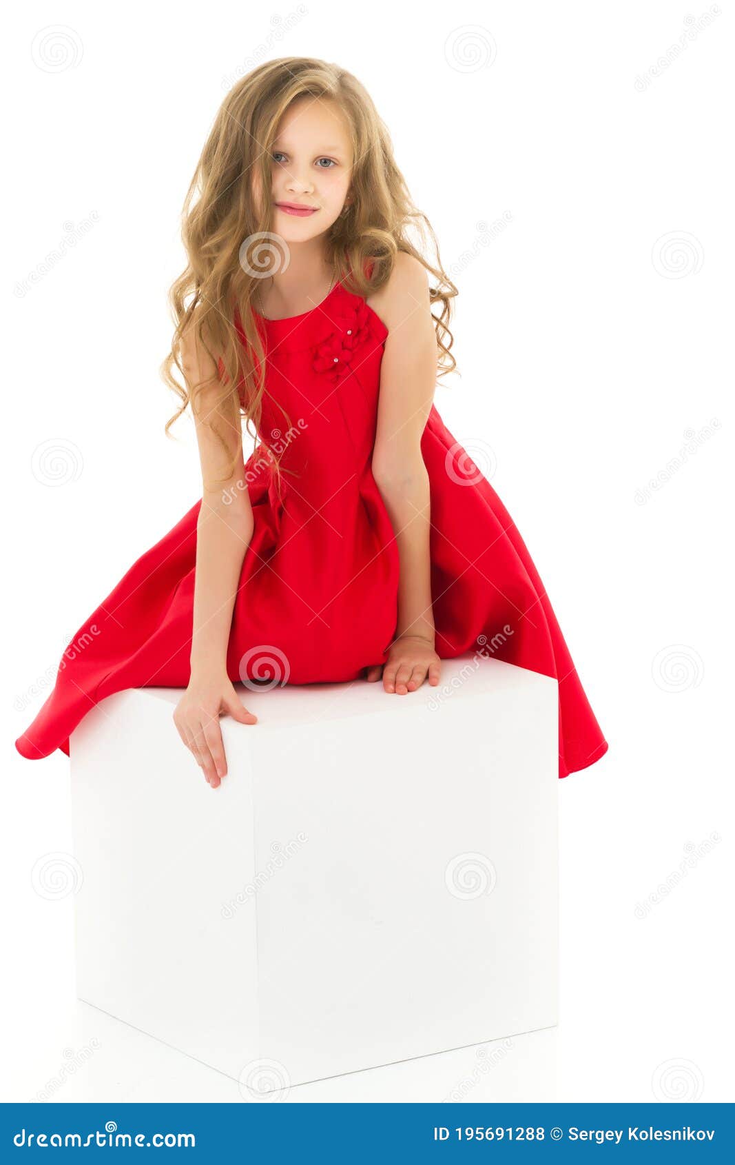 Portrait of Beautiful Preteen Girl in Red Dress Posing in Studio