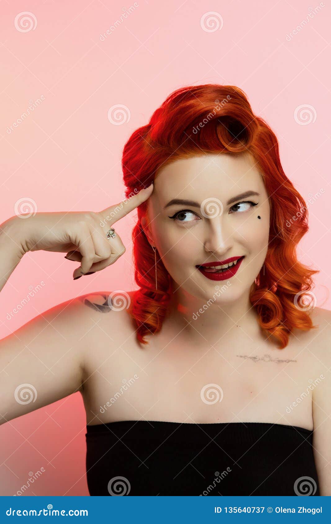 Portrait Of A Beautiful Red Hair Girl With Pin Up Make Up And Hair