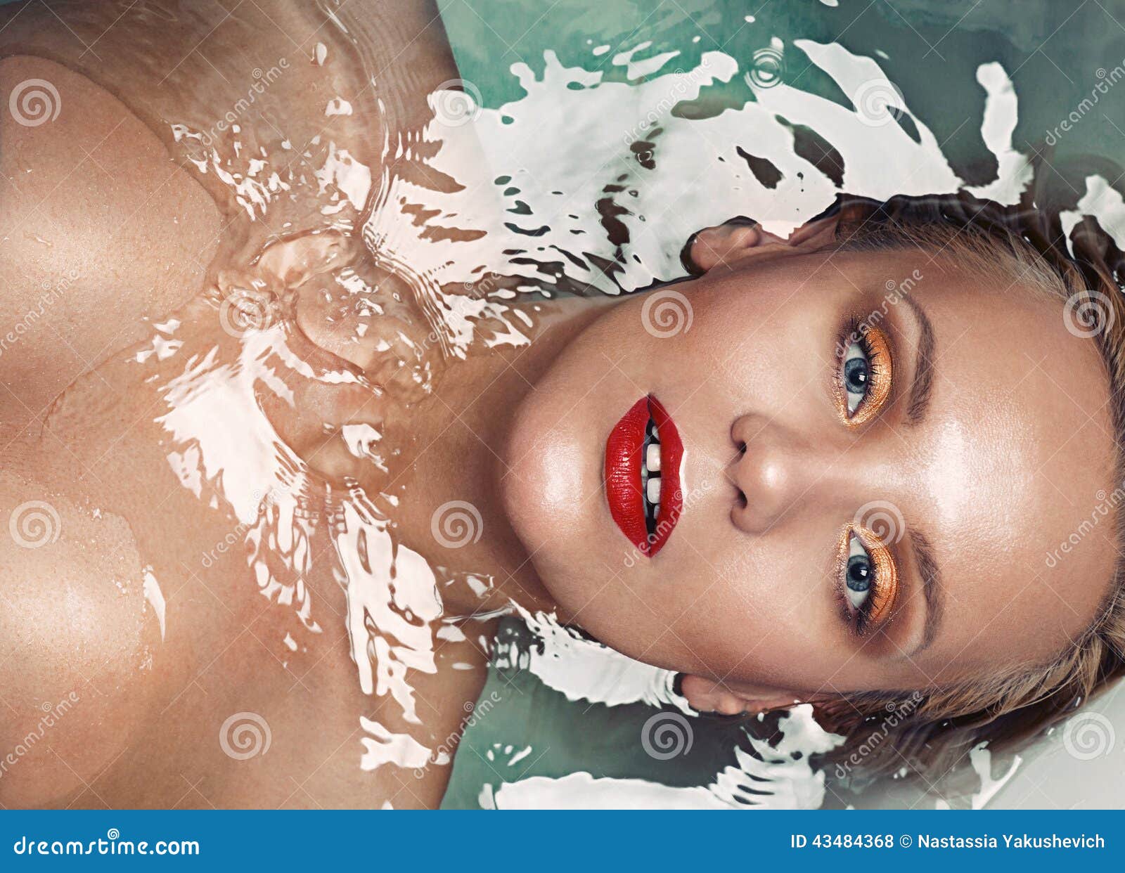 portrait of a beautiful sensual glamourous blonde in water, vogue concept