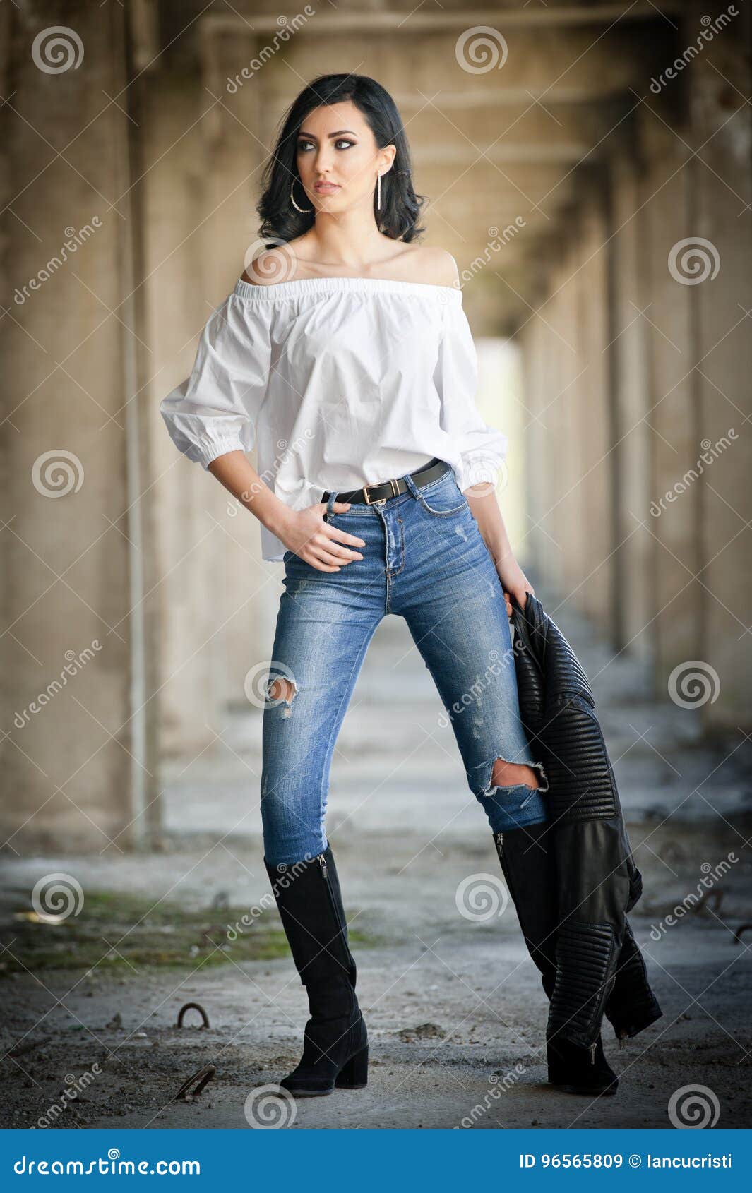 Young Woman In White Leather Jacket In A Tshirt In Black Jeans