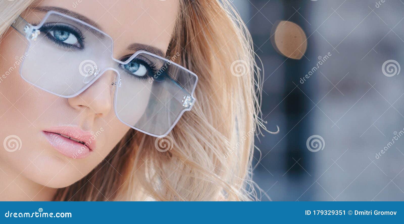 Portrait Of Beautiful Stylish Blonde Woman In Blue Sunglasses In
