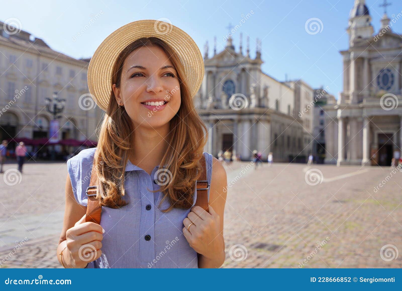 portrait of beautiful tourist woman in piazza san carlo square in turin, italy. traveler girl with turin landmarks in italy