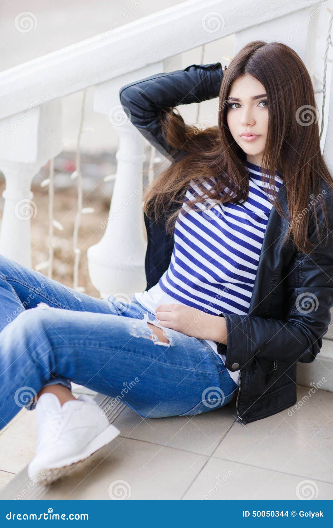 Portrait Of A Beautiful Woman Sitting On The Steps Stock