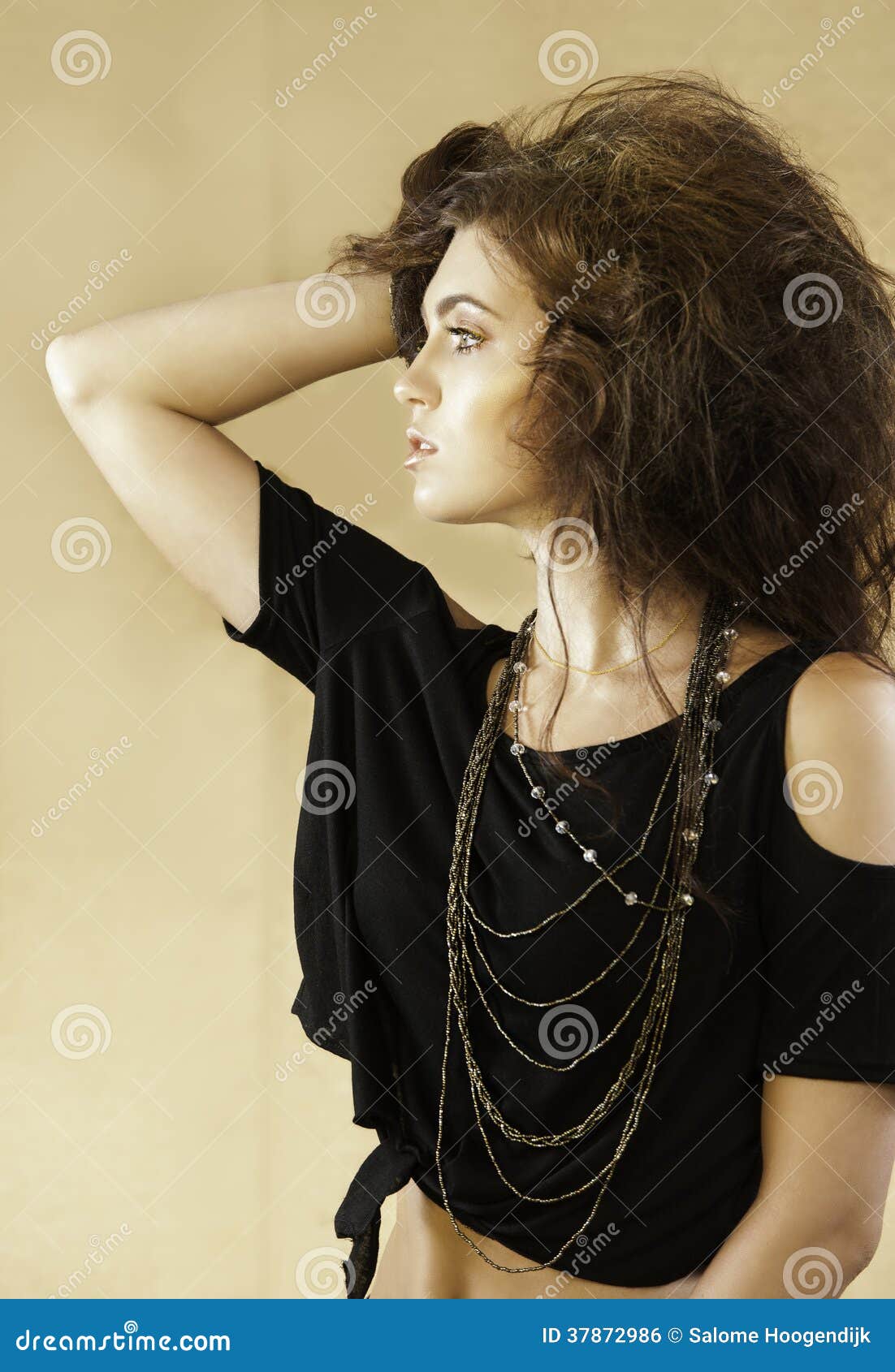 portrait of beautiful woman with wild auburn hair looking to the side