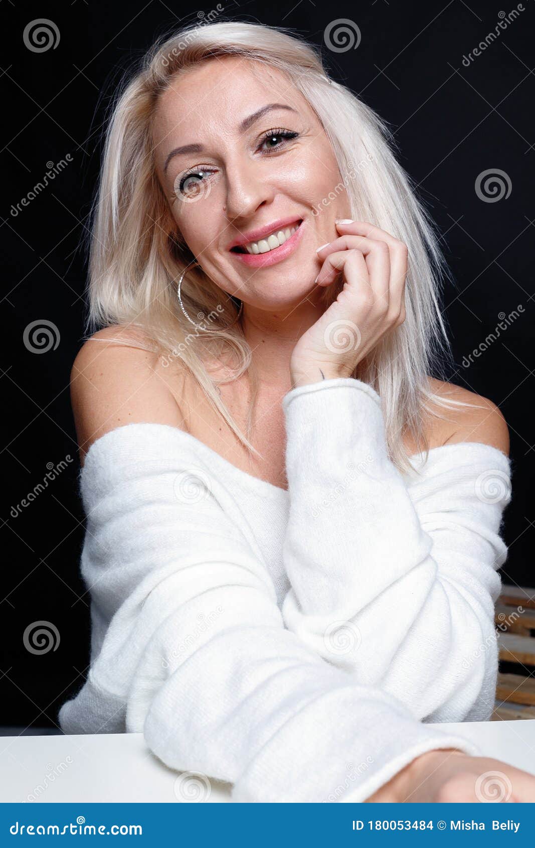 Portrait Of A Beautiful Young Attractive Woman In A White Sweater Stock