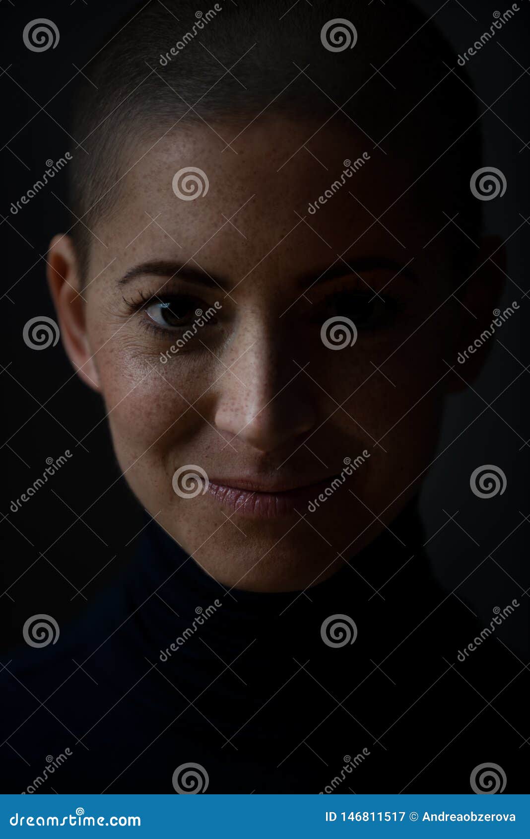 portrait of a beautiful young courageous smiling female cancer patient, with shaved head. woman, a cancer patient, portrait.