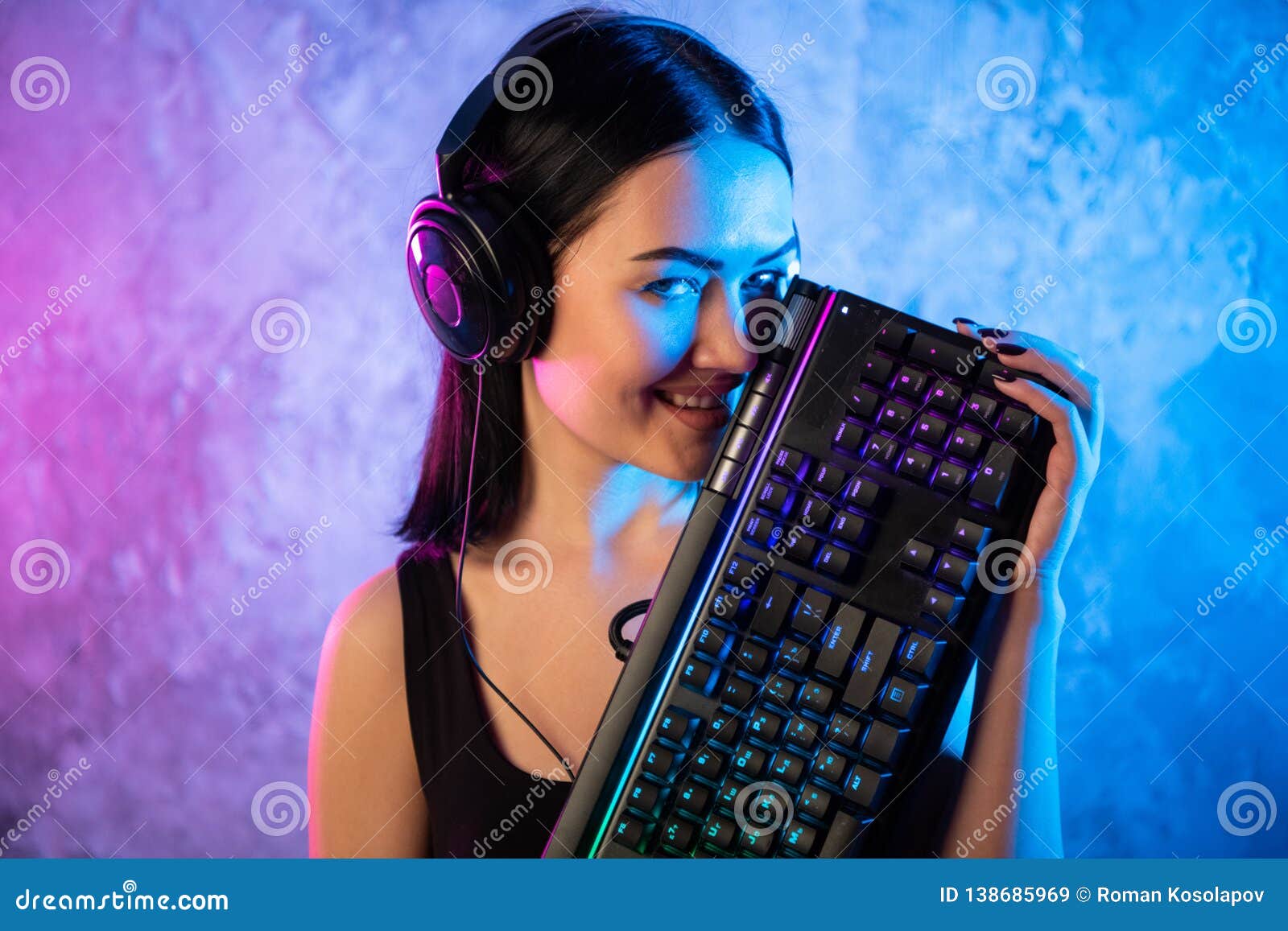 Portrait Of The Beautiful Young Pro Gamer Girl Standing With A Gaming Keyboard And Headset And 