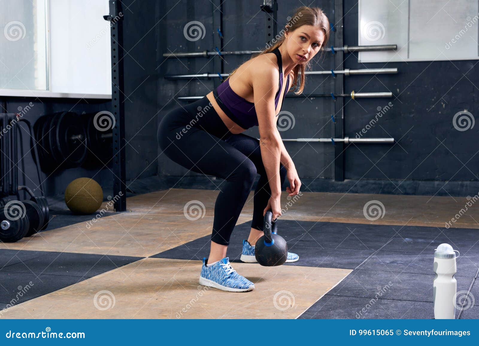 Young Woman Lifting Kettlebell in Gym Stock Image - Image of squat ...