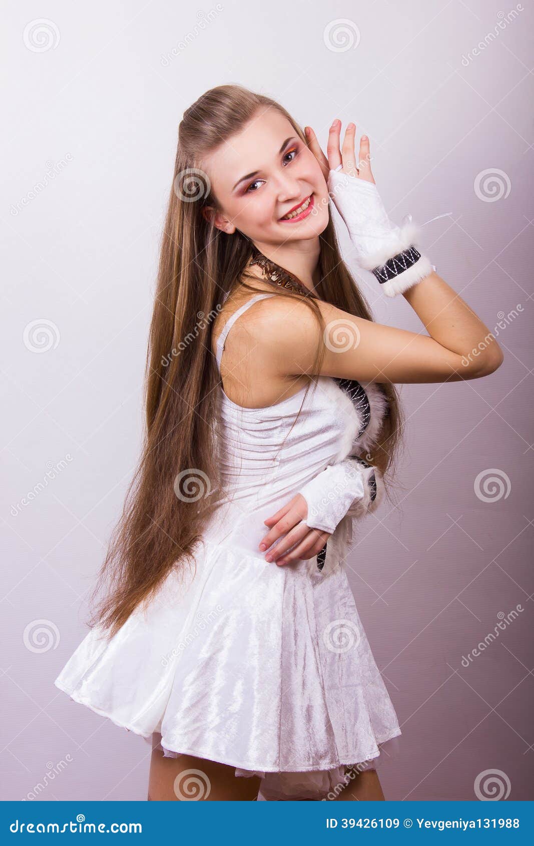 Portrait of a beautiful young woman with long hair in a studio. Girl dressed in carnival costume on Halloween birds