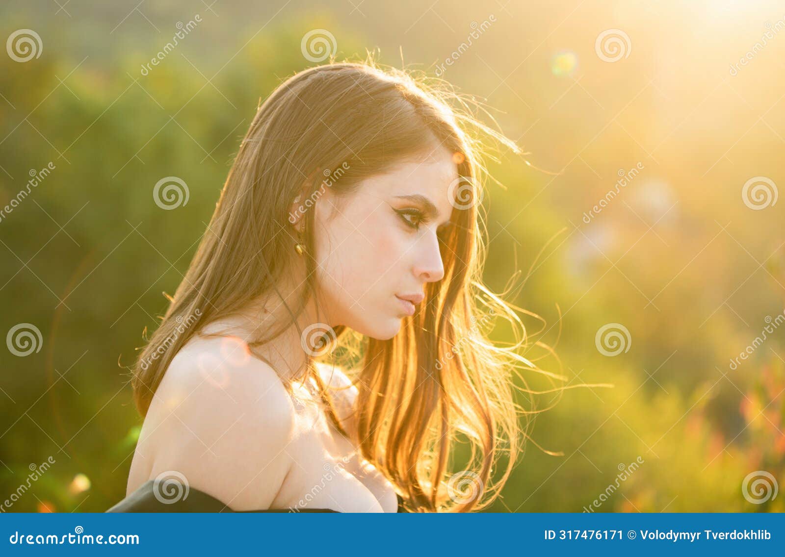 portrait of beautiful young woman looking eways in summer park. outdoor portrait of a cute girl. happy cheerful female