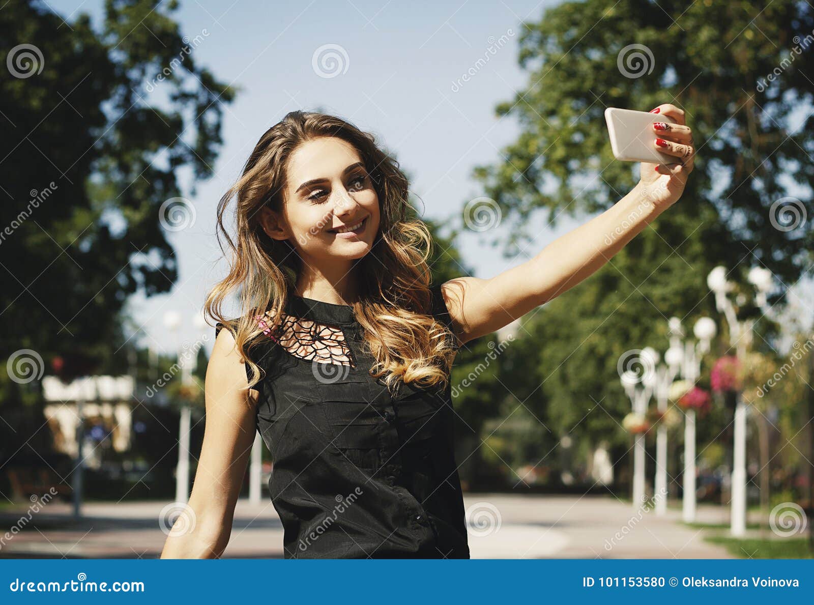 Portrait Of A Beautiful Young Woman Making Selfie On Smart Phone Stock