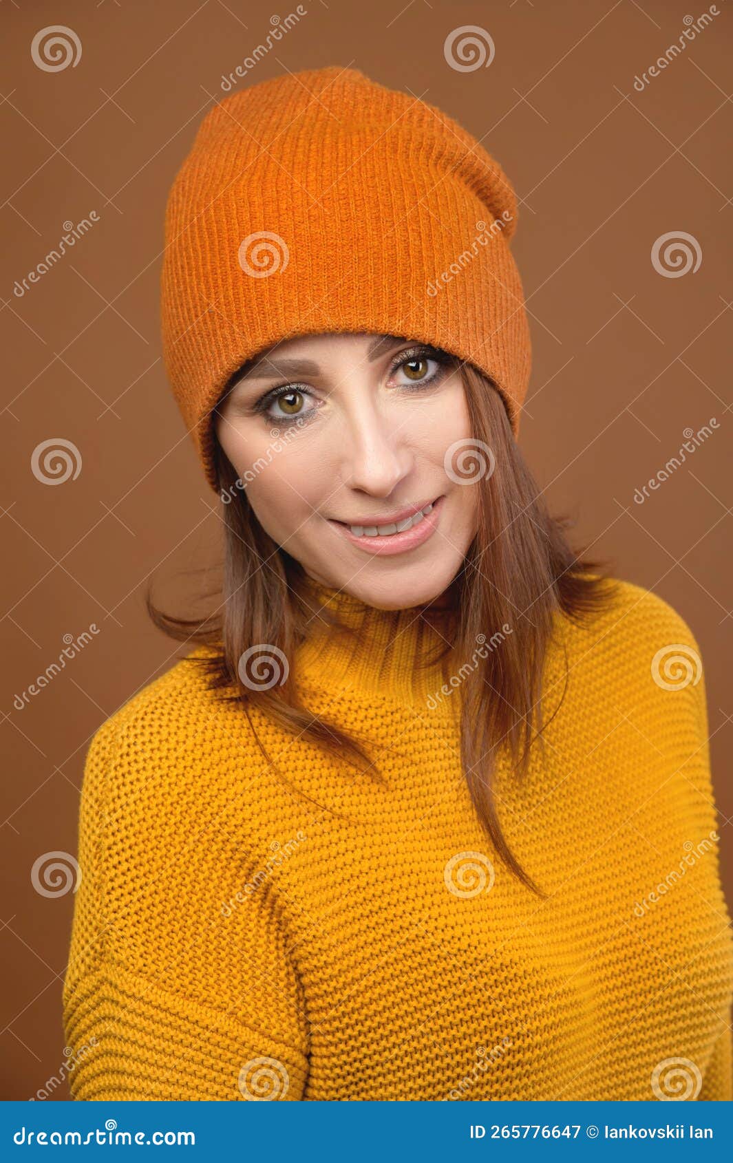 Portrait of a Beautiful Young Woman in Orange, in a Sweater and a Hat ...