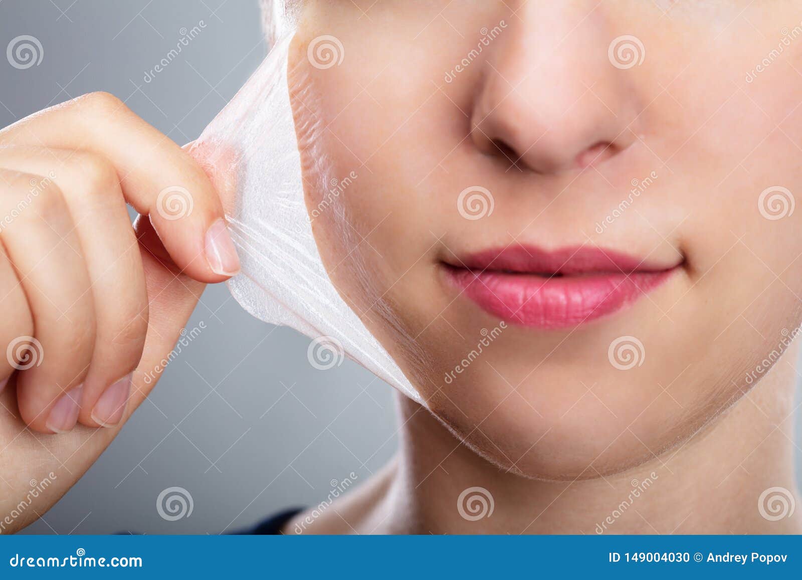 woman removing peeling mask from her face