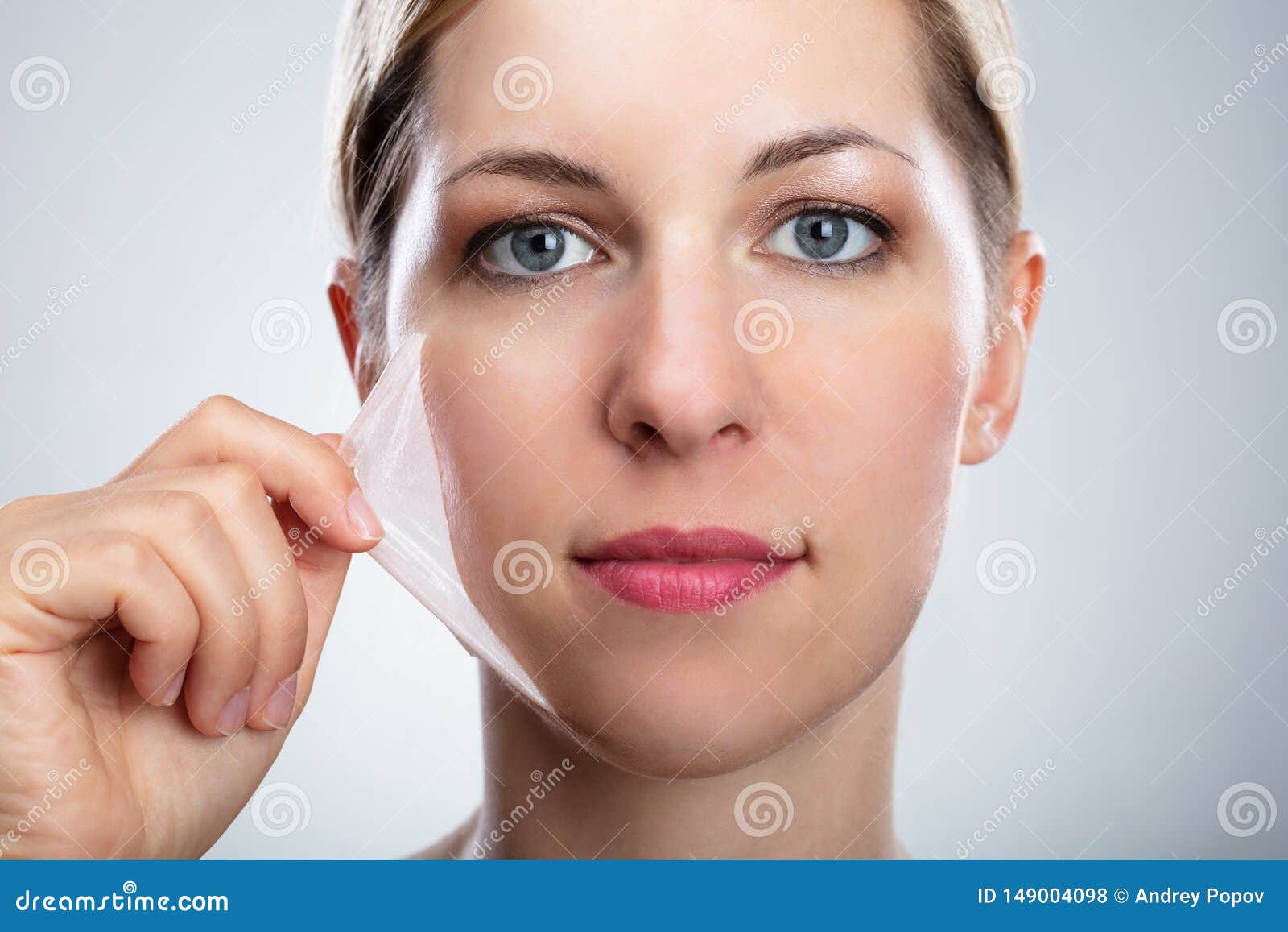 woman removing peeling mask from her face