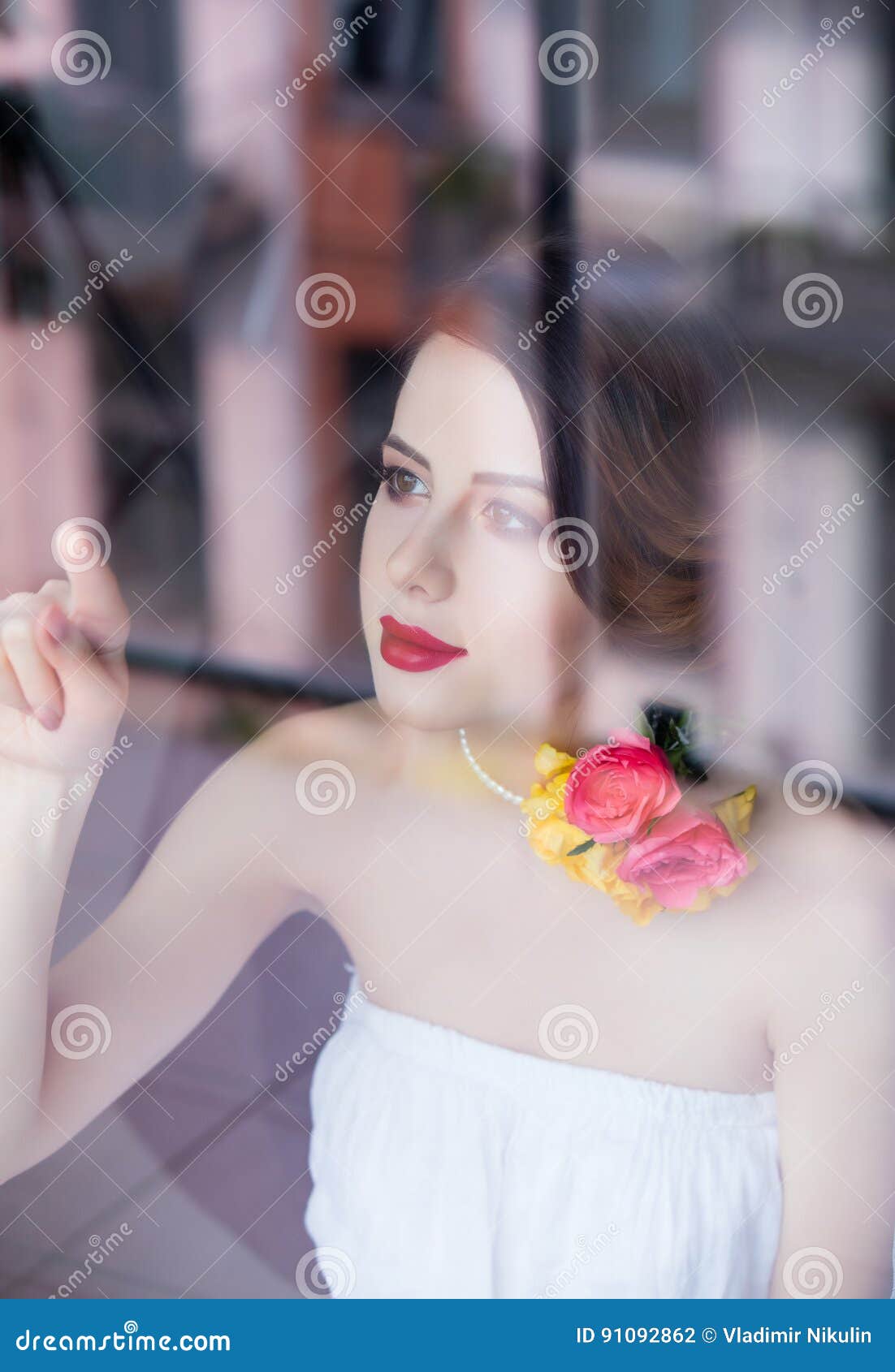 Portrait Of Beautiful Young Woman Standing Near The Window And L Stock