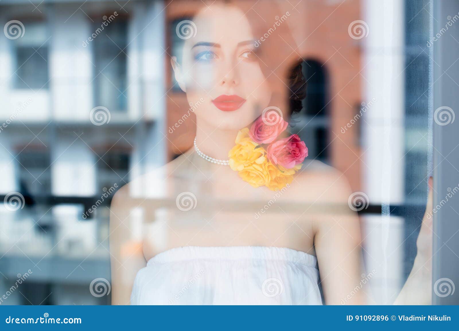 Portrait Of Beautiful Young Woman Standing Near The Window And L Stock