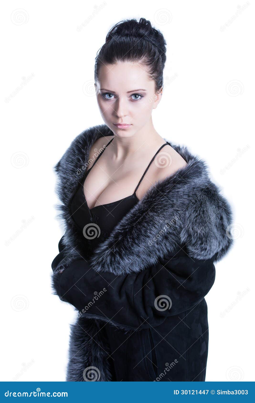 beautiful brunette with decollete in luxury black color fur coat