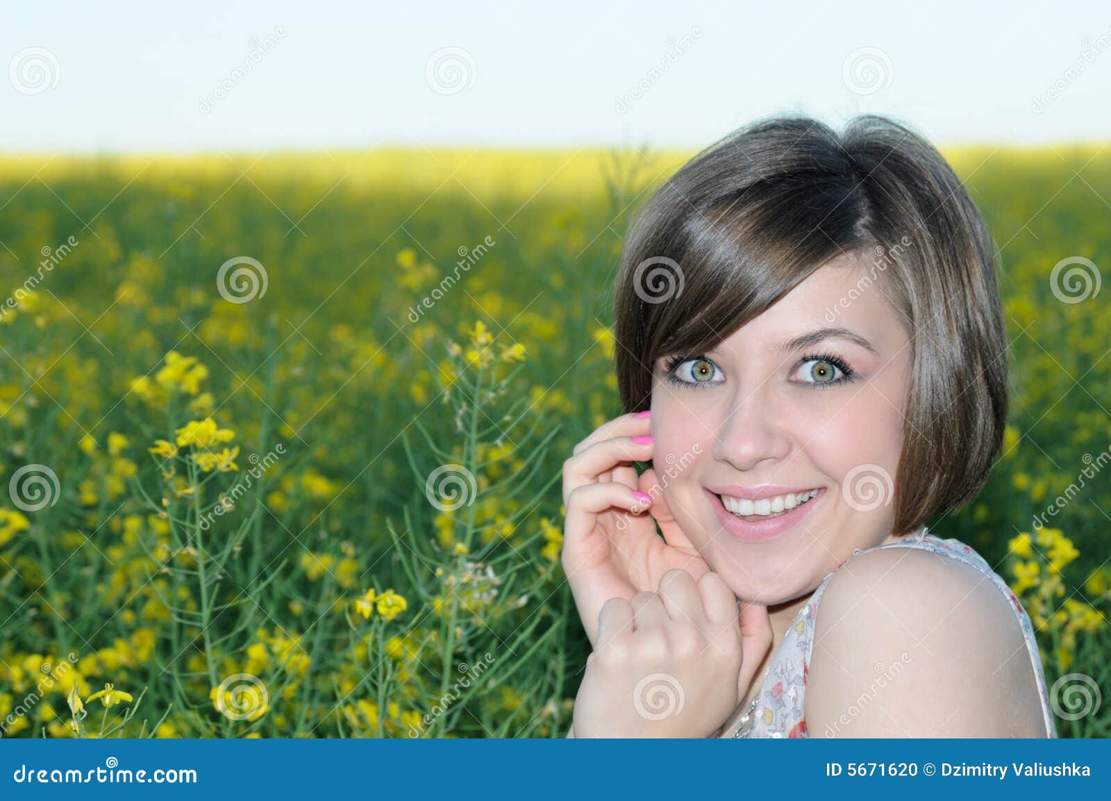 portrait of the beauty girl on yellow meadow