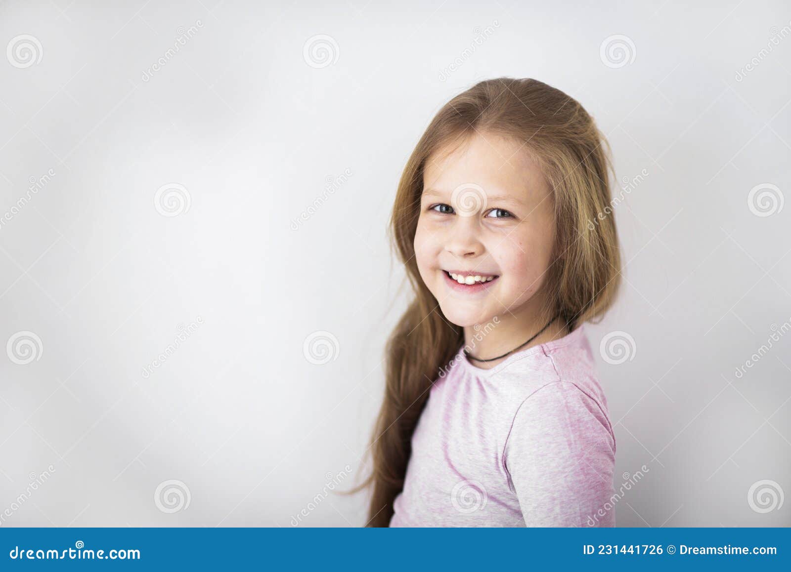 beautiful little girl in a chic pink dress poses sitting on a gray  background and throws confetti. fashion and style. space for text. photo in  the studio. High quality photo 20484170 Stock