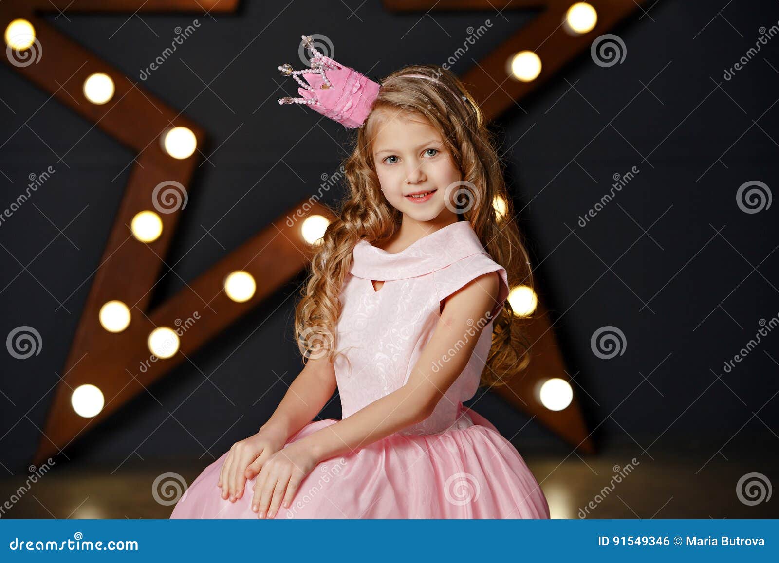 Portrait of a Blonde Girl in a Pink Dress and Crown on the Background ...
