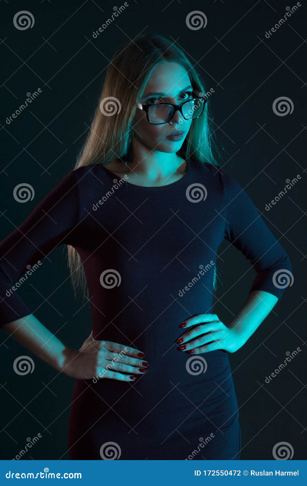 Portrait Of A Blonde With Long Hair In A Gray Suit Glasses Stock