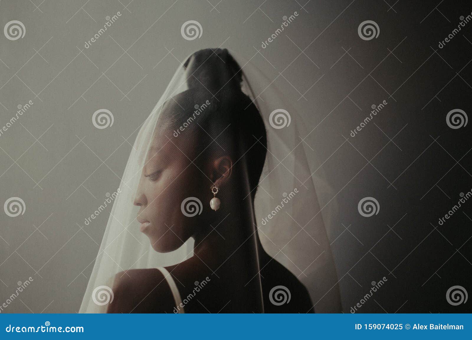 portrait of blushing bride in wedding dress and veil