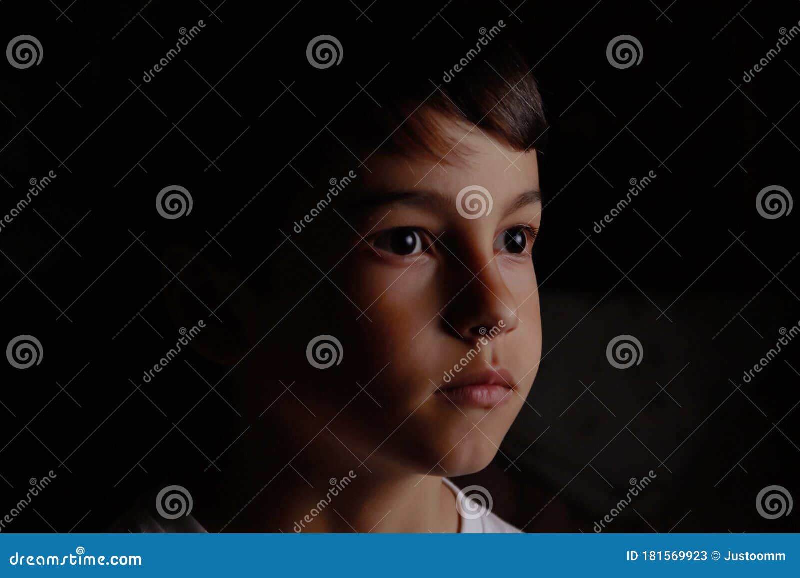 Portrait of a Boy on a Dark Background Close Up Face Stock Image