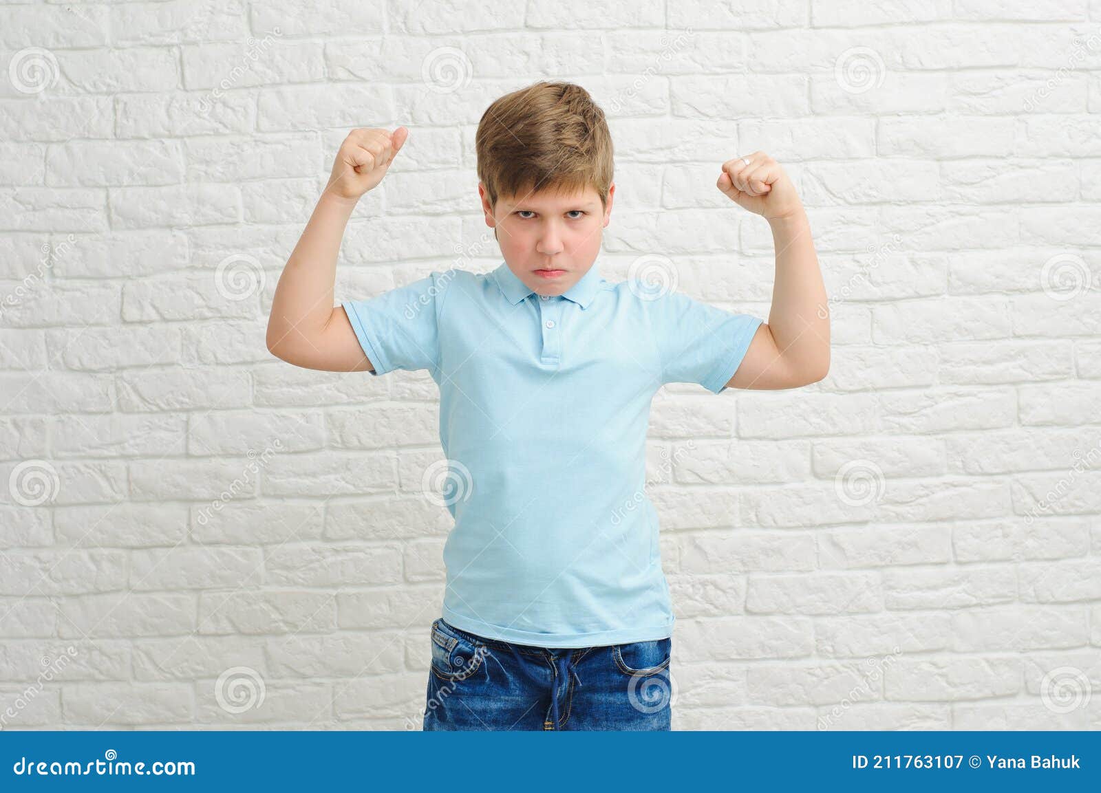 portrait of a boy of european appearance on a light background, blond boy 9 years old. funny strong child