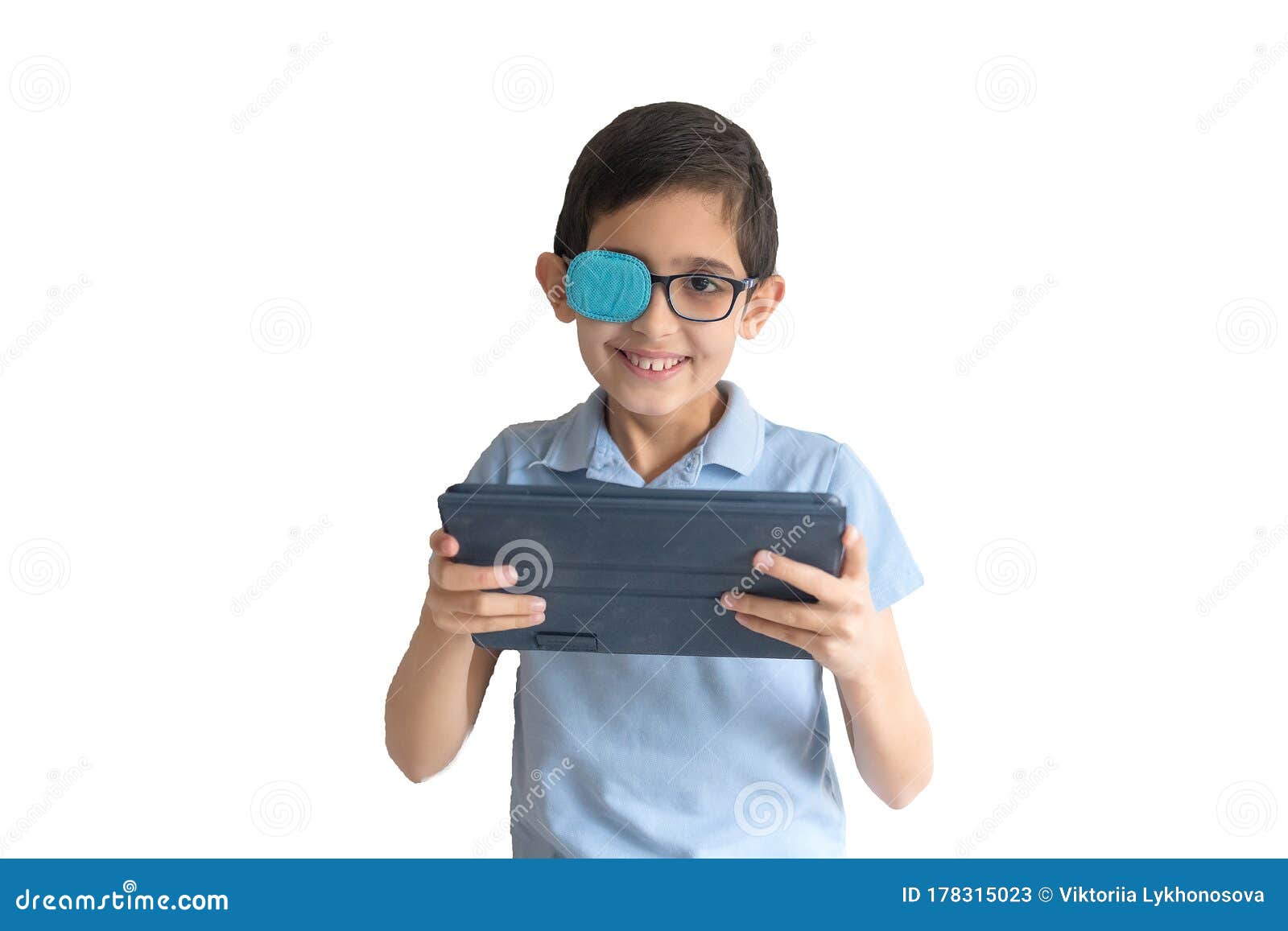 portrait of boy in glasses with patch for glasses. boy with tablet. treat lazy eye, amblyopia, strabismus.  remote learning. dista
