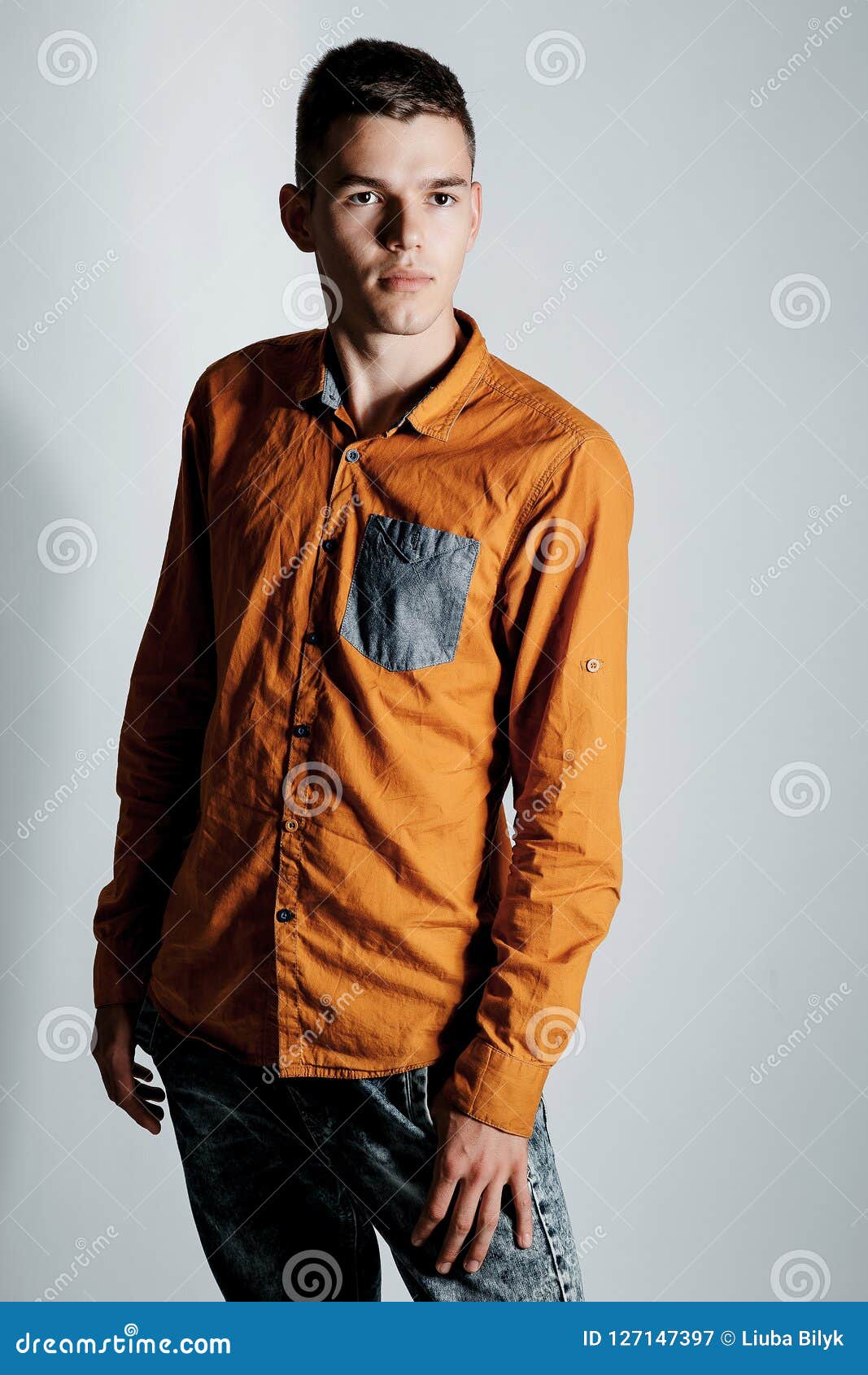 Portrait Of A Boy In A Photo Studio. Young Man Posing On A White ...