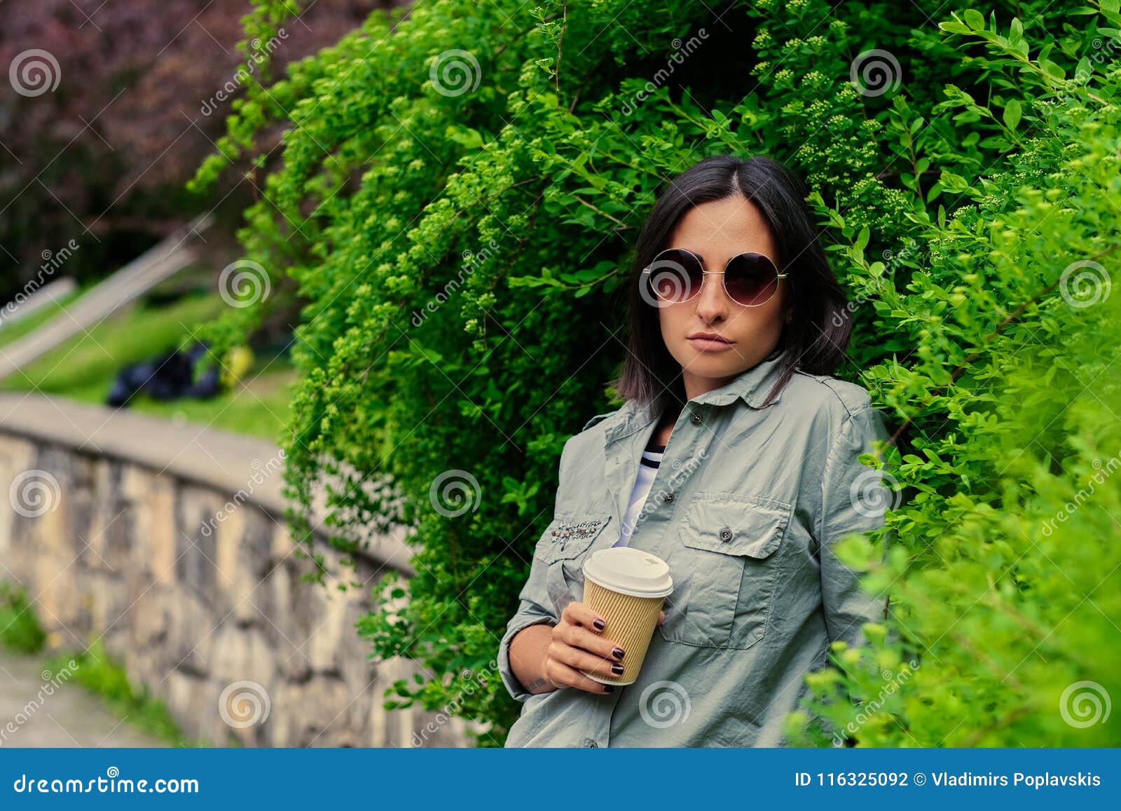 Brunette Female in Sunglasses Drinks Coffee in a Summer Park. Stock ...