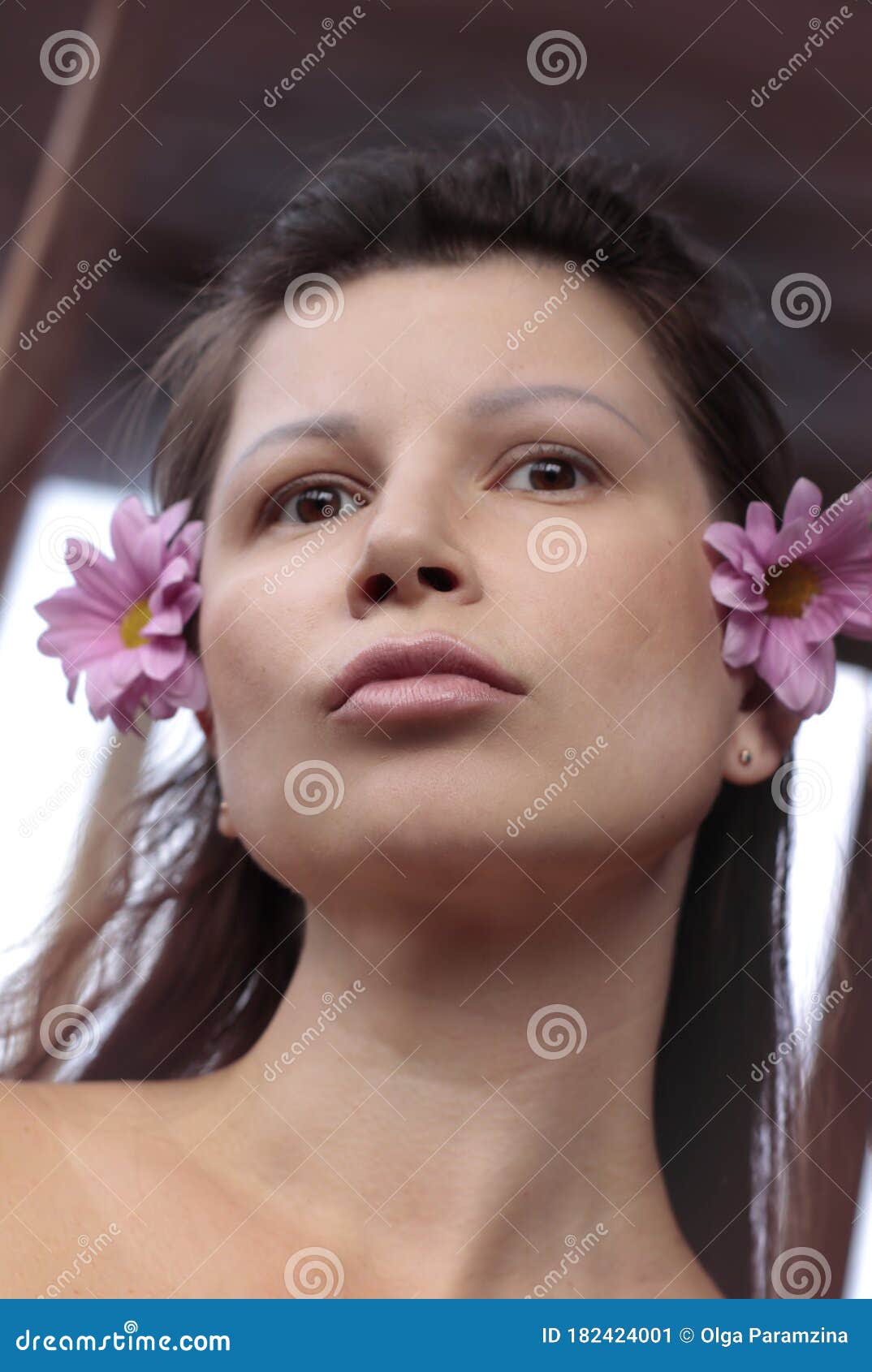 Portrait Of A Brunette Girl With Flowers Tanned Skin Brown Eyes